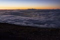 Haleakala twilight above the clouds and city lights below