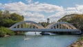 HALEIWA, UNITED STATES OF AMERICA - JANUARY 12 2015: paddle boarders pass under the bridge in haleiwa