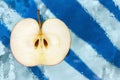 Half an apple on a blue background