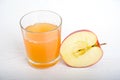 Half apple with glass of naturally cloudy juice