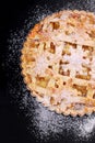 A half of apple pie sprinkled with powdered sugar on black background Royalty Free Stock Photo