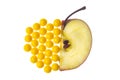 Half an apple and yellow dragees with vitamins in place of the second half of the apple Royalty Free Stock Photo