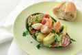 Half avocado stuffed with tomato, shrimp and parsley garnish wit