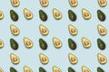 Pattern of half of avokado on blue background. Royalty Free Stock Photo