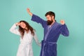 Half awake. Couple in love look sleepy in morning. Sleepy woman and hipster stretch and yawn blue background. Early