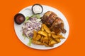 Half baked chicken with potatoes and salad. Royalty Free Stock Photo