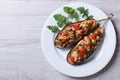 Half baked eggplants with meat, cheese and tomatoes