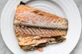 Half baked salmon tail part white plate