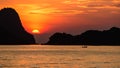 Half beautiful sun and white cloud in orange sky with silhouette fisherman on long tail boat and islands in the sea as foreground. Royalty Free Stock Photo