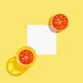 Half of bloody orange with white paper card note and two glasse with water or lemonade on bright yellow background. Summer