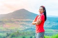 Half-body photo of a female trail runner wearing pink runner, sportswear, smiling, looking at the camera. on the gravel ground on