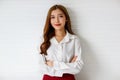 Half-body portrait shot of attractive young adult Asian woman in formal long sleeve white shirt looking to a copy space at the Royalty Free Stock Photo