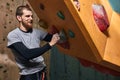 Sportsman with physical disability inspecting artificial climbing wall Royalty Free Stock Photo