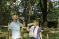 Half body view of two mature friends drinking filtered water after jogging together outdoors in the park Royalty Free Stock Photo