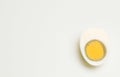 Half boiled peeled egg in a white cup on a white background Royalty Free Stock Photo