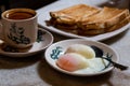 Half boiled eggs, coffee, toast bread, popular Chinese style breakfast in Malaysia Royalty Free Stock Photo