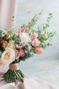 Half a bouquet of eucalyptus and roses and peonies for a background on pastel light background