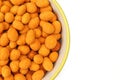 Half bowl full of chili paprika coated peanuts snack isolated on white background Royalty Free Stock Photo