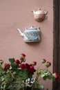 Half ceramic teapots glued on the wall of house in Vilnius