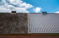 A half cleaned house roof shows the before and after effect of a roof cleaning Royalty Free Stock Photo