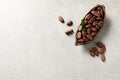 Half of cocoa pod with beans on light table. Space for text Royalty Free Stock Photo