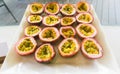 Half cut passion fruits on white plate. Ripe passion fruit isolated on table. Royalty Free Stock Photo