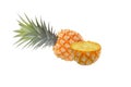 The half-cut pineapple has a juicy texture placed in front of the bright yellow ripe pineapples on a white background Royalty Free Stock Photo