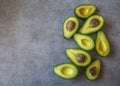 Half cut ripe avocados with seed on dark grey background, top view flt lay Royalty Free Stock Photo