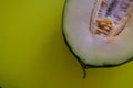 Half of the cut ripe melon with seeds on one-ton green background. Useful fruit. Summer. Season. Vitamins. Royalty Free Stock Photo