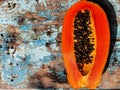 : Half-Cut Ripe Papaya: A Healthy Fruit on a Blue Painted Wooden Background Royalty Free Stock Photo