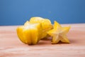 Half cut of starfruit on wooden table