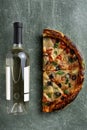 Half a delicious homemade italian pizza on the table, pizza with wine, copy space for your text, Royalty Free Stock Photo