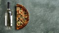 Half a delicious homemade italian pizza on the table, pizza with wine, copy space for your text, Royalty Free Stock Photo