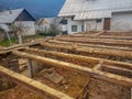 Half destroyed barn with wooden beams down below