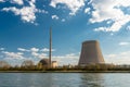 A half-dismantled nuclear atomic chimney against a blue sky with clouds in Mulheim-Karlich in western Germany, on the Rhine river.