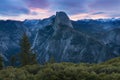 Half Dome and Yosemite Valley in Yosemite National Park during colorful sunset with trees and rocks. California, USA Royalty Free Stock Photo