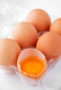 Half dozen of extra large brown eggs with one cracked Royalty Free Stock Photo