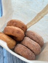 Half dozen of mixed classic plain and sugar cinnamon donuts in paper bag