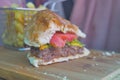 half eaten beef burger on table close up Royalty Free Stock Photo
