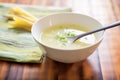 half-eaten bowl of potato leek soup showing spoon and napkin Royalty Free Stock Photo