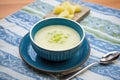 half-eaten bowl of potato leek soup showing spoon and napkin Royalty Free Stock Photo