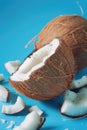 Half eaten coconut on blue surface, suitable for tropical themes Royalty Free Stock Photo