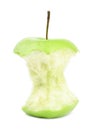 Half eaten green apple on white