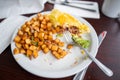 Half-eaten omelette and roasted potatoes on a white plate