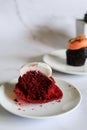 Half-eaten red velvet cupcake with butter cream on white background. Royalty Free Stock Photo