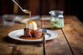 half-eaten sticky toffee pudding with spoon on rustic table Royalty Free Stock Photo