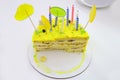 half eaten yellow children\'s birthday cake with candles Royalty Free Stock Photo