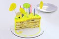 half eaten yellow children\'s birthday cake with candles Royalty Free Stock Photo