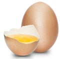 A half egg with the yolk inside with a whole egg on a white background. Royalty Free Stock Photo
