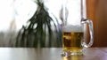 Half empty beer mug on table